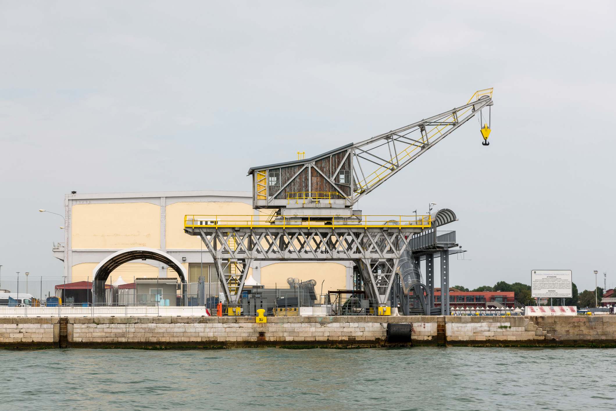 Large industrial crane in a port area by the water showcasing urban infrastructure
