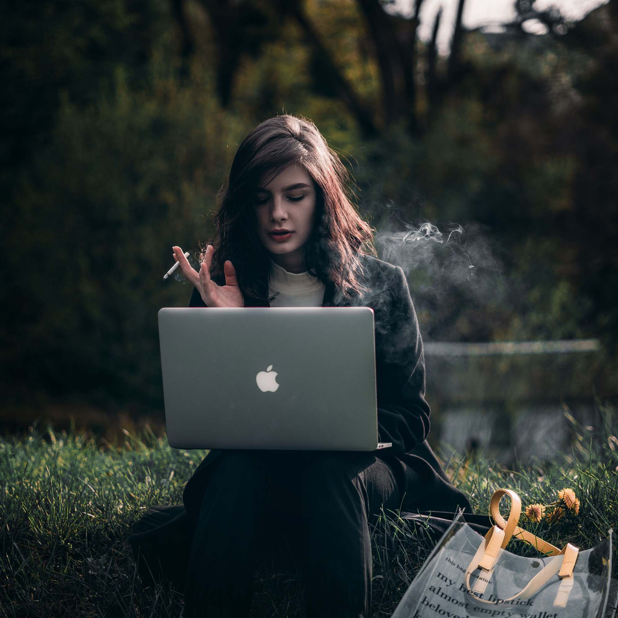 Working on a laptop outside surrounded by nature